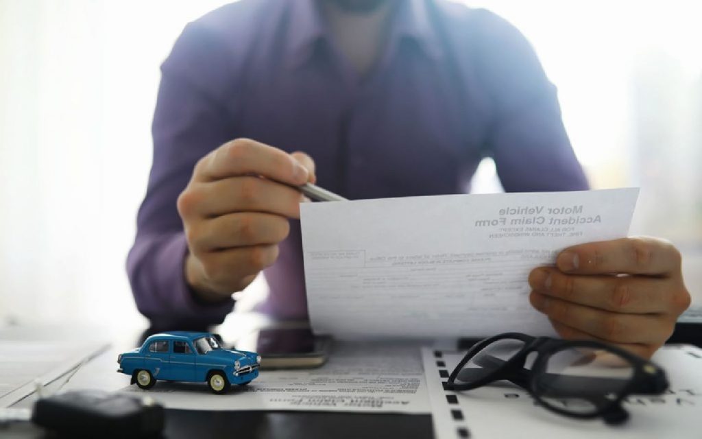 A person filing documents according to the UAE car registration rules for Sharjah
