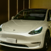 Tesla vehicle on display in Bangkok, highlighting Tesla Autopilot technology features and design.
