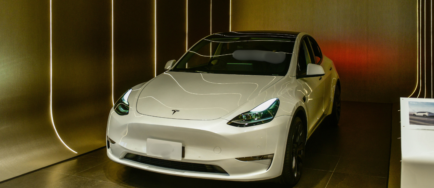 Tesla vehicle on display in Bangkok, highlighting Tesla Autopilot technology features and design.