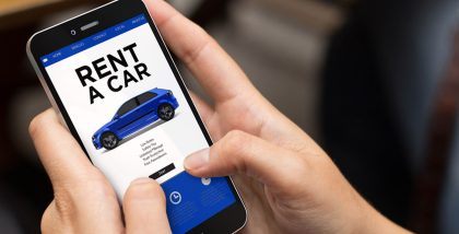 Man checking phone for renting a car in Abu Dhabi