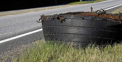 Blown out car tyre on road