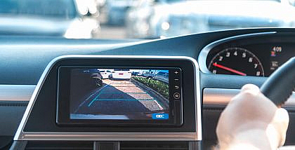 A man reversing car with the help of rear camera