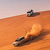 Two 4-wheel cars in the deserts of Dubai