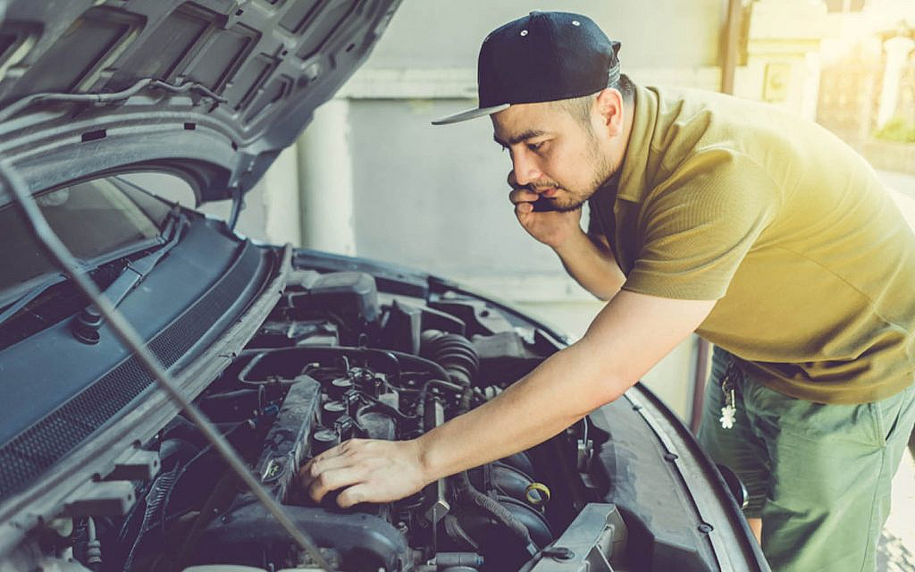 Man checking his car’s engine