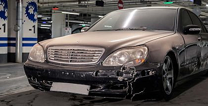 abandoned Mercedes-Benz Sedan in a shopping centre parking lot