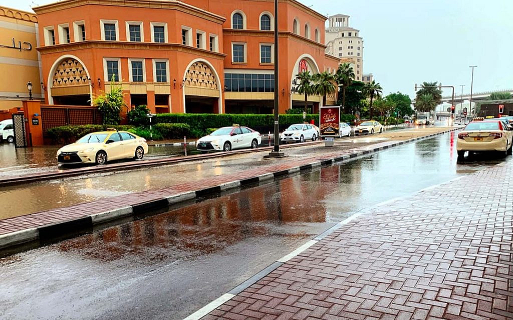 Cars driving on a flooded street of Dubai during a heavy rain spell