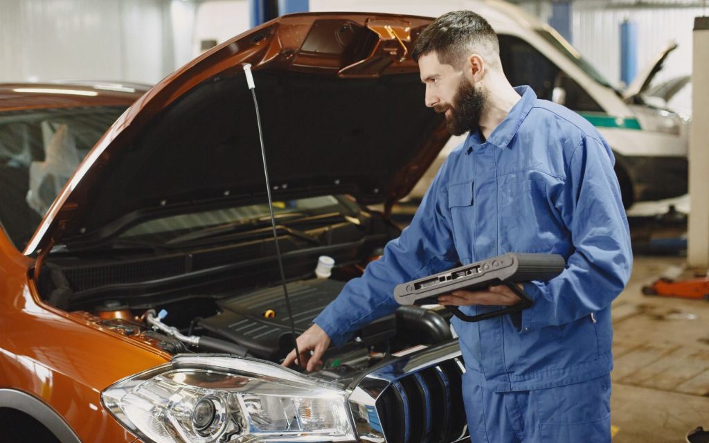 A mechanic inspecting a vehicle