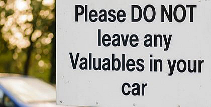 A road sign that reads do not leave valuables in your car