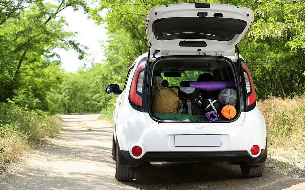 A car with camping equipment on the road