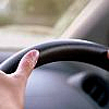 Driver with hands on steering wheel