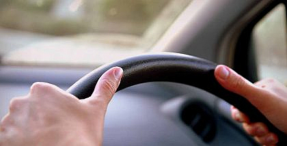 Driver with hands on steering wheel