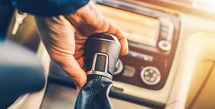 A person changing manual gear of a car