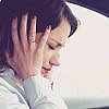 Woman covering her ears to avoid car sound