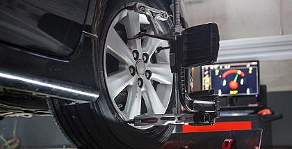 A car in workshop for wheel alignment