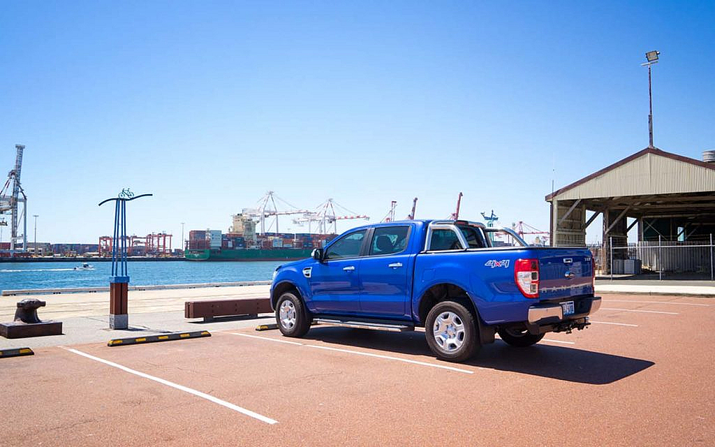 Blue coloured pickup truck Ford Ranger parked at the harbour