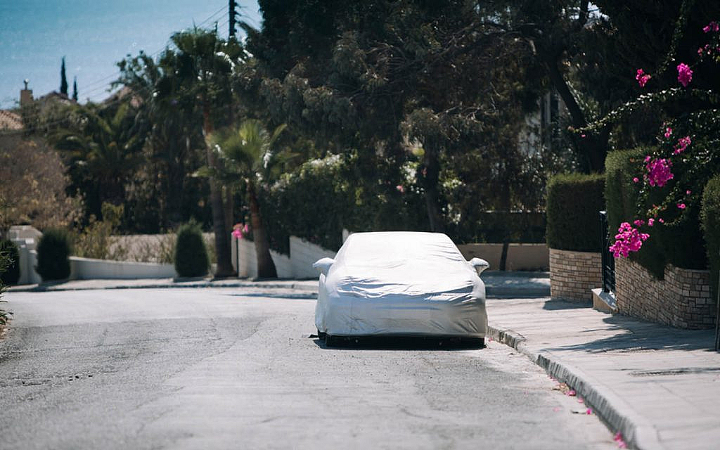 Car covered with a protective cover