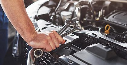 A man checking car engine