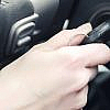 Man trying to take out car key stuck in ignition