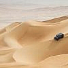 A 4x4 driving across desert in Abu Dhabi