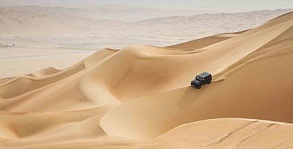 A 4x4 driving across desert in Abu Dhabi