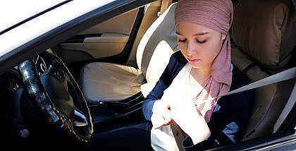 Woman fixing the seat belt for safety