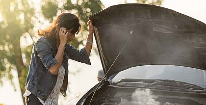 A women calling as her car broke down due to overheating
