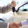 A man giving car keys to another