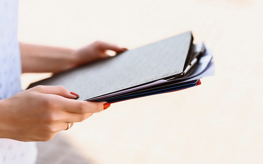 A woman carrying documents in files