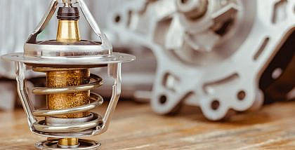 Car thermostat on a wooden table