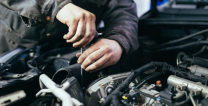 A mechanic is detecting a car vacuum leak