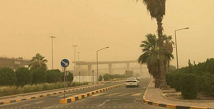 A car on the road during a dust storm