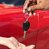 Women receiving a key from car rental owner in Dubai