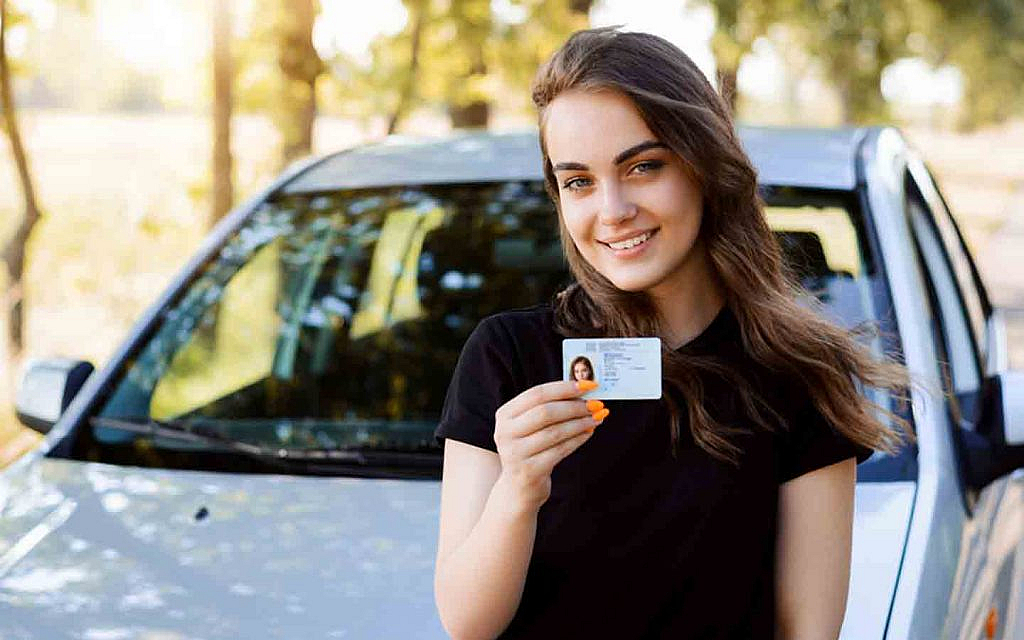 A girl showing her a driving license card