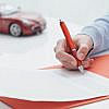 Man signing a document after selling a car with a loan