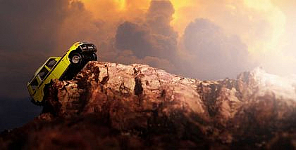 A 4-wheel drive crossing a rocky terrain