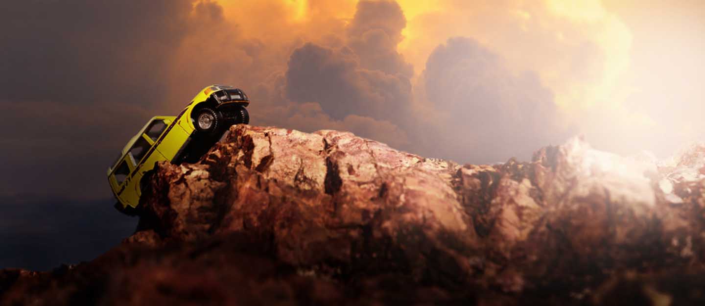 A 4-wheel drive crossing a rocky terrain