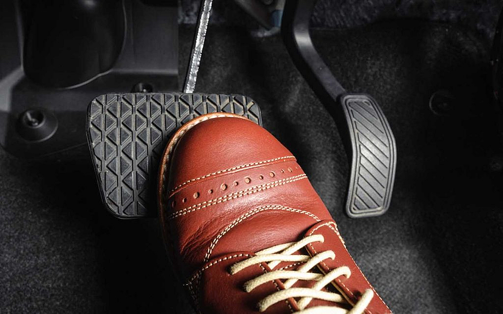 A man applying brakes in a vehicle 