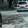 cars moving in flooded waters