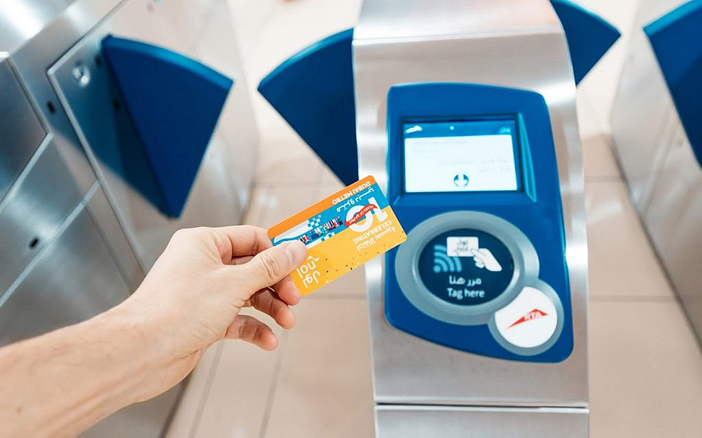 Woman tapping her NOL card in Dubai at a turnstile