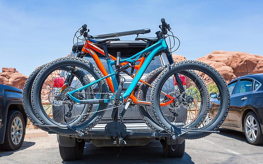 bikes loaded on the back of a car