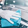 A person is cleaning a car to reduce the maintenance cost