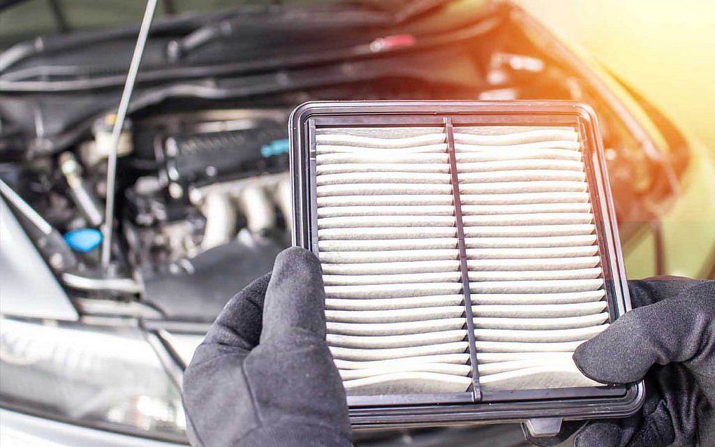 Man checking car air filter