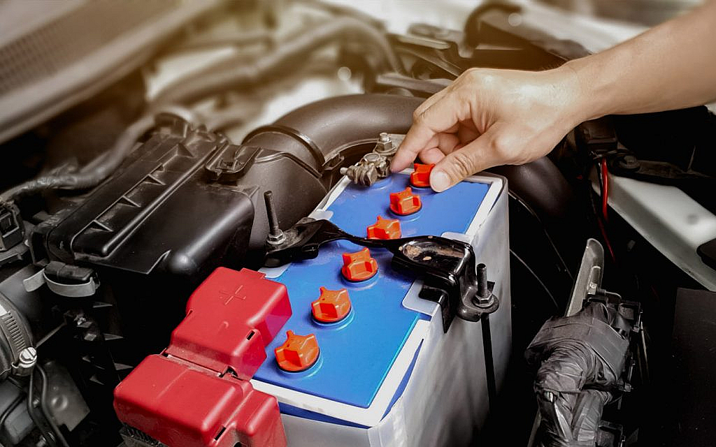 A person checking car battery