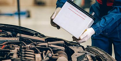 A mechanic changing a car battery