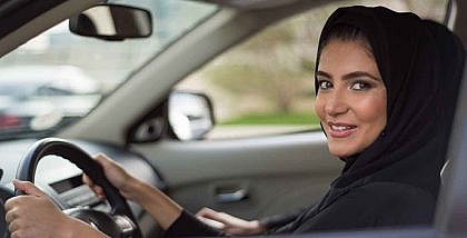 A woman driving a borrowed car