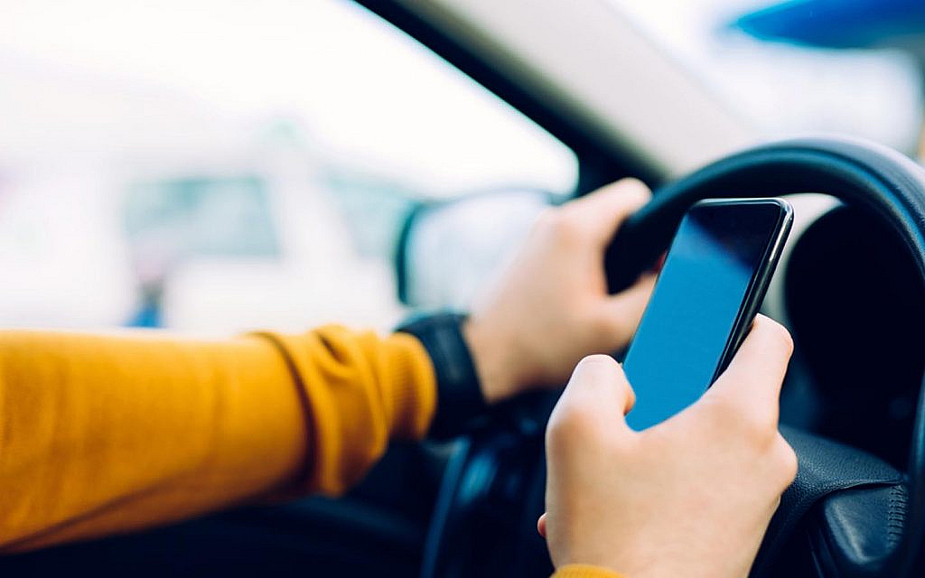 A person is using a phone while driving