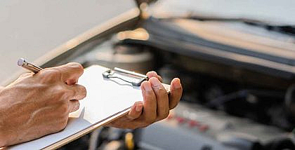 The auto mechanic checks the car engine