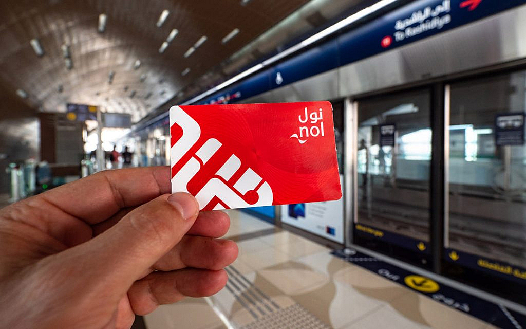 Woman holding a red nol card