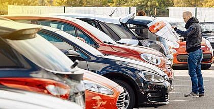 Man inspecting a used car’s exterior