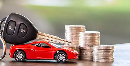 red car and key on stacks of coin